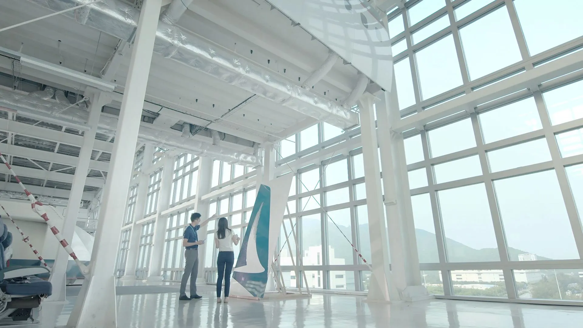 Live-action shot of designers looking at the tail design