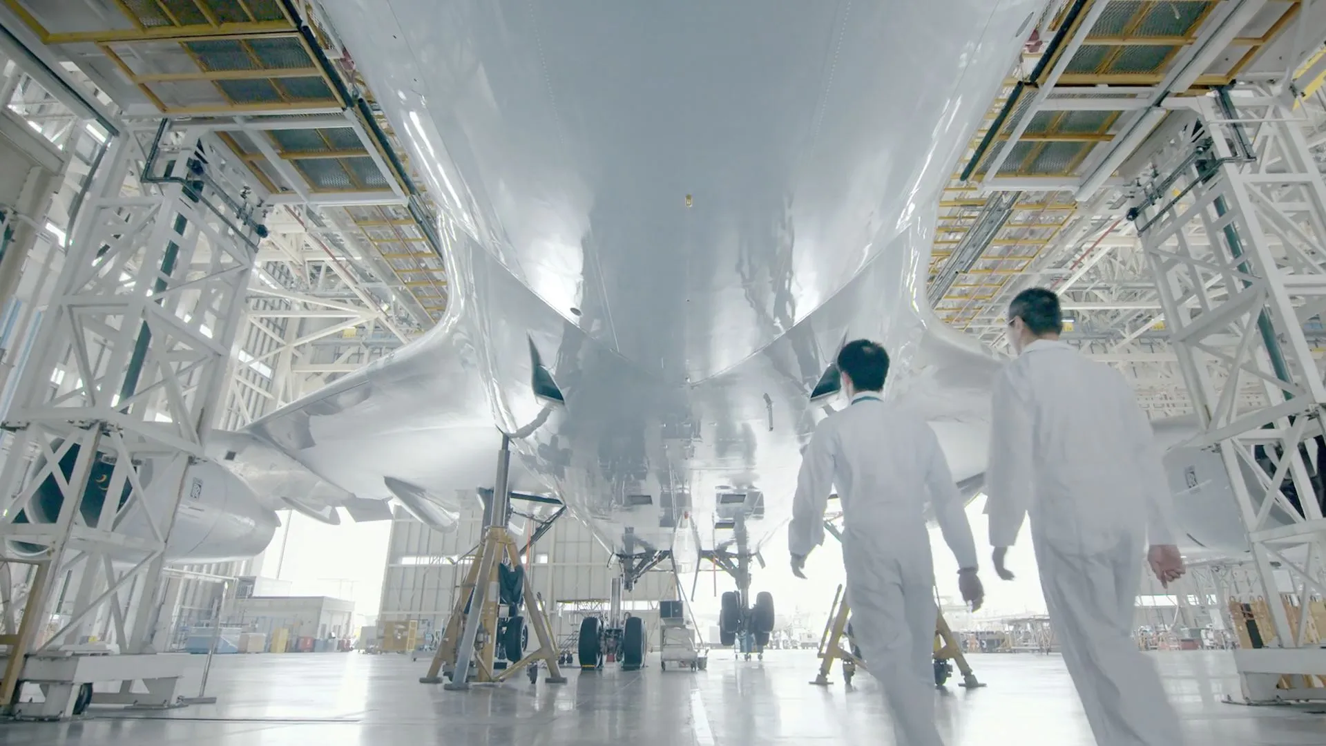 Live-action shot of painters underneath the plane