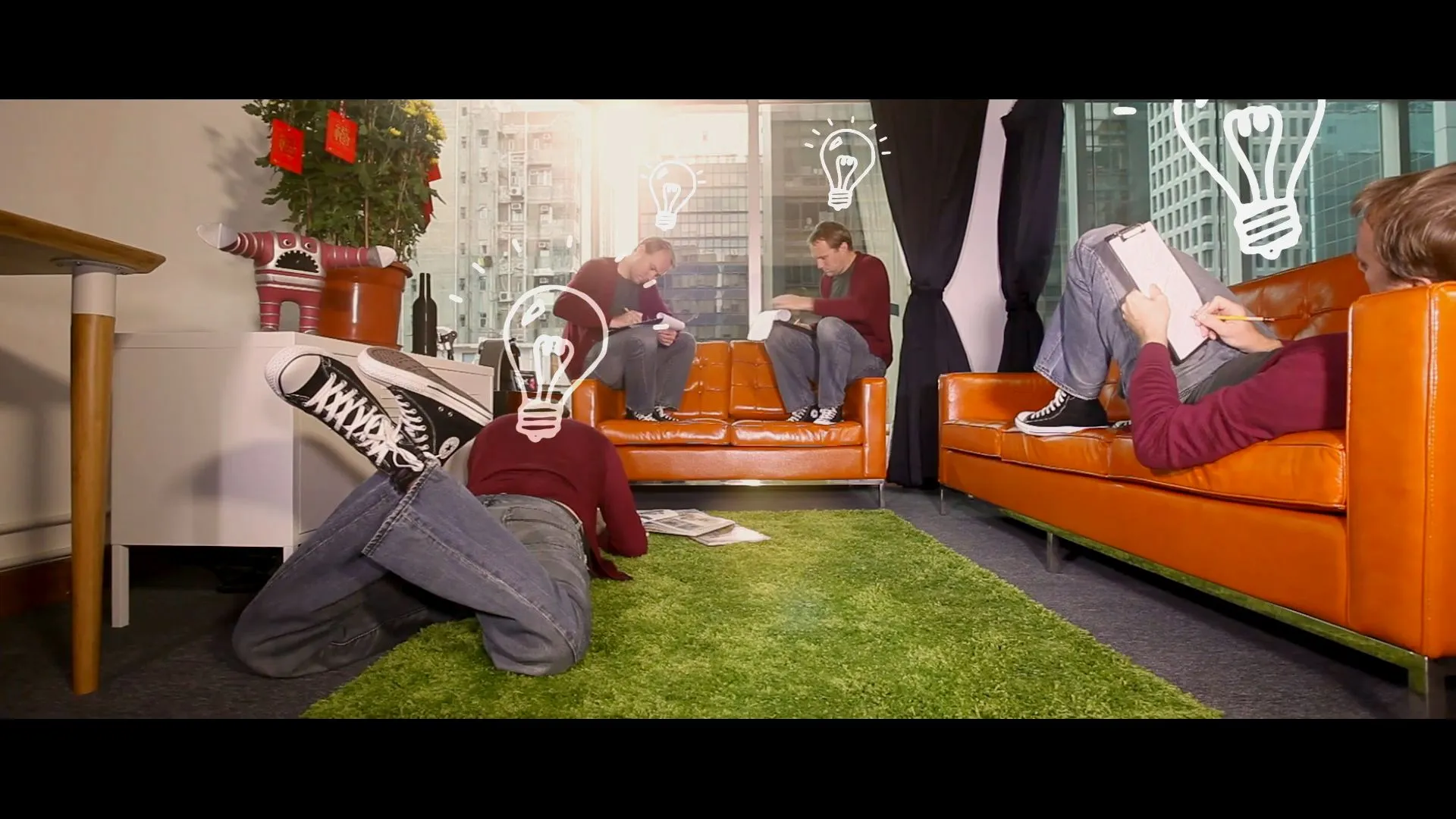 A creative professional brainstorming with animated lightbulbs around him.