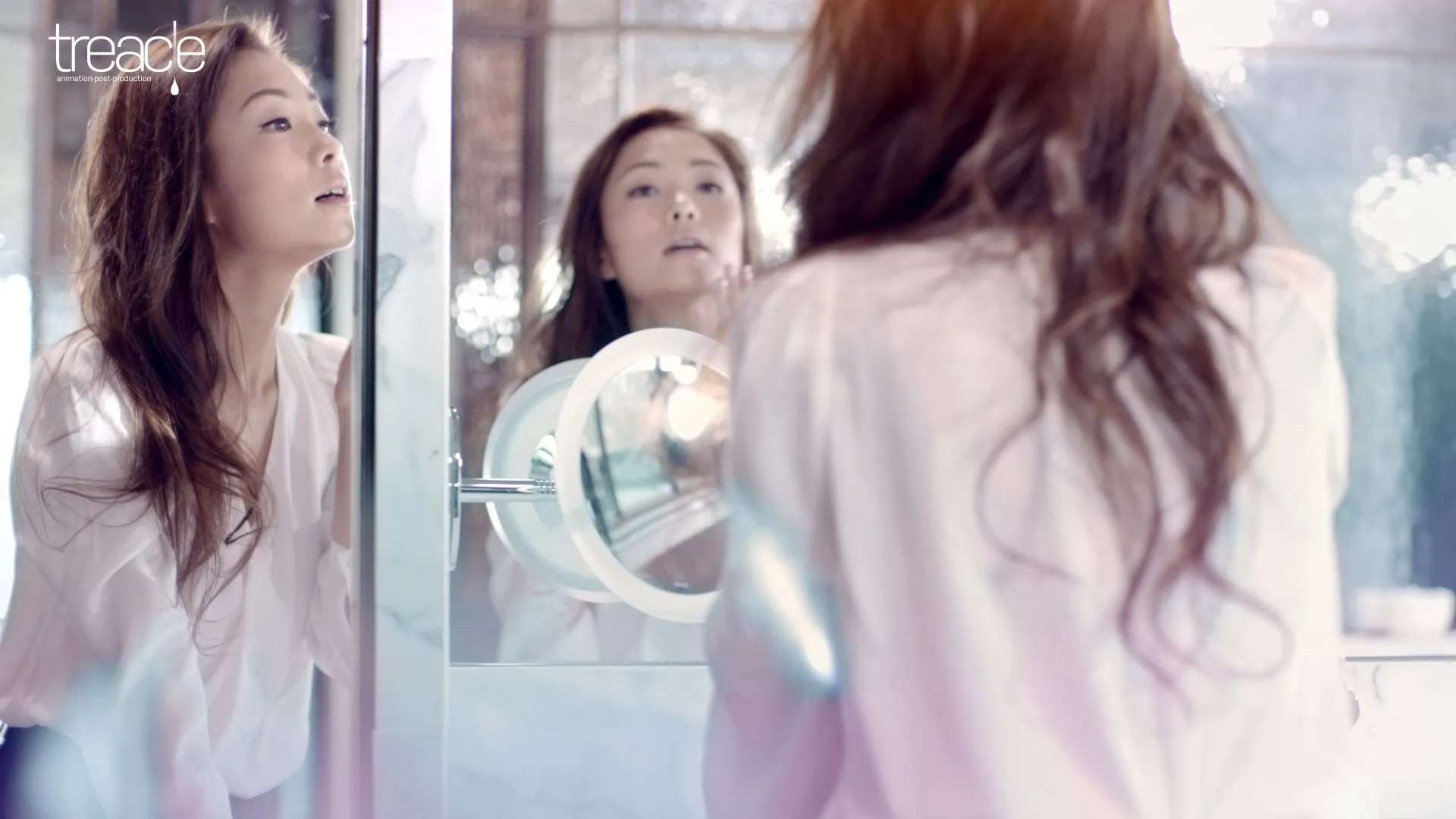 Beautiful woman looking at herself in a mirror.