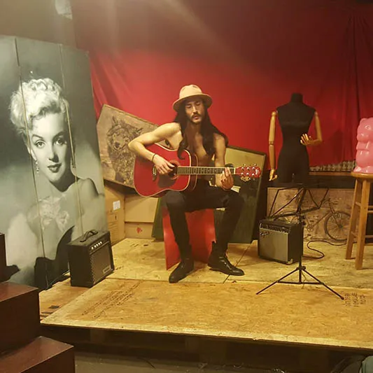 On location shot of a male model with a guitar.